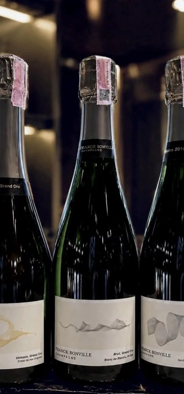 Franck Bonville Grand Cru Champagne collection featuring multiple cuvées, including Blanc de Blancs, displayed together in the winery cellar.