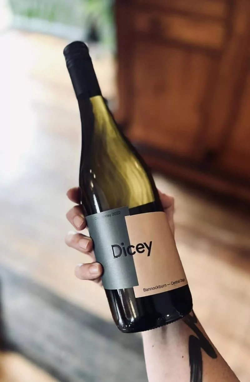 Hand holding a bottle of Dicey Chardonnay from Bannockburn, Central Otago, New Zealand.