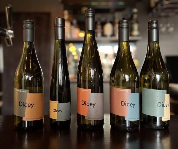 Selection of Dicey wine bottles displayed together, featuring the winery's range of Central Otago varietals.