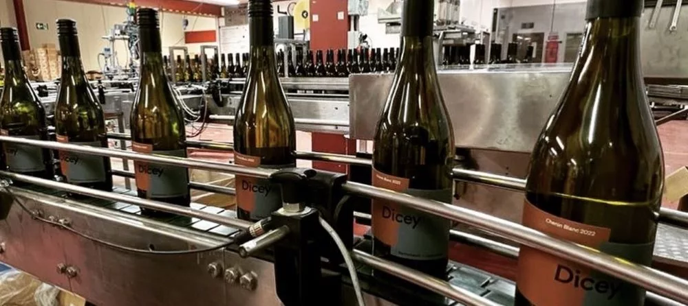 Dicey wine bottles moving along the bottling line during production at the winery in Central Otago, New Zealand.