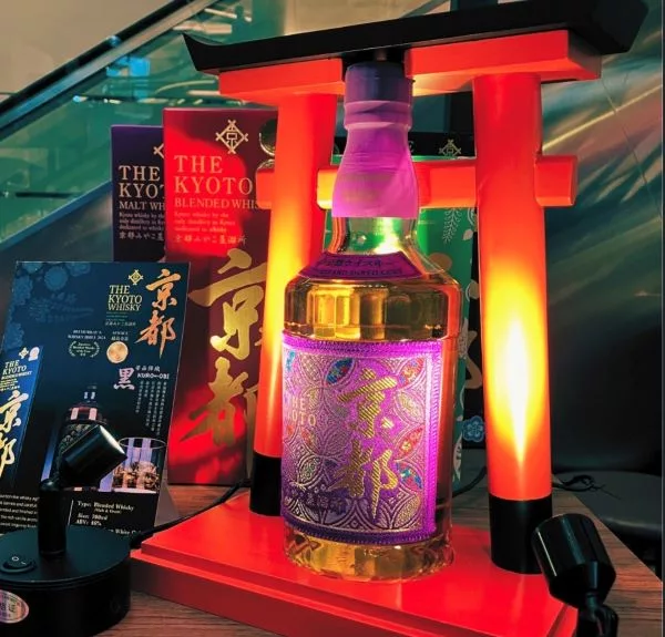 The Kyoto Shuzo Purple Edition Japanese whisky displayed with illuminated Japanese torii-inspired presentation and premium packaging.