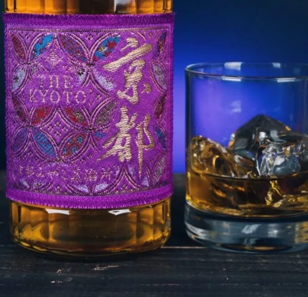 Close-up of The Kyoto Shuzo Purple Edition Japanese whisky served with an old fashioned glass over ice.