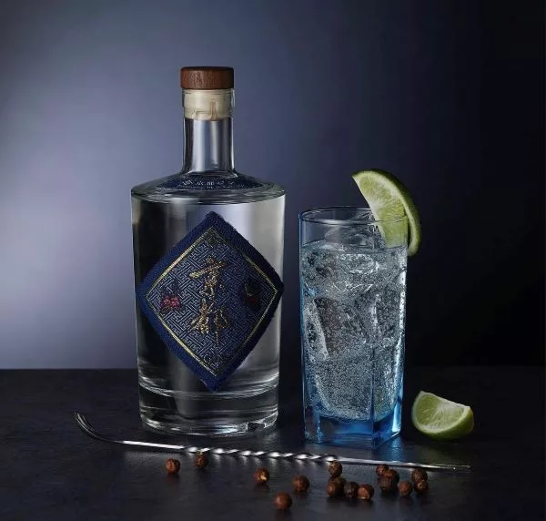 The Kyoto Shuzo craft gin bottle served with a refreshing gin and tonic garnished with fresh lime.